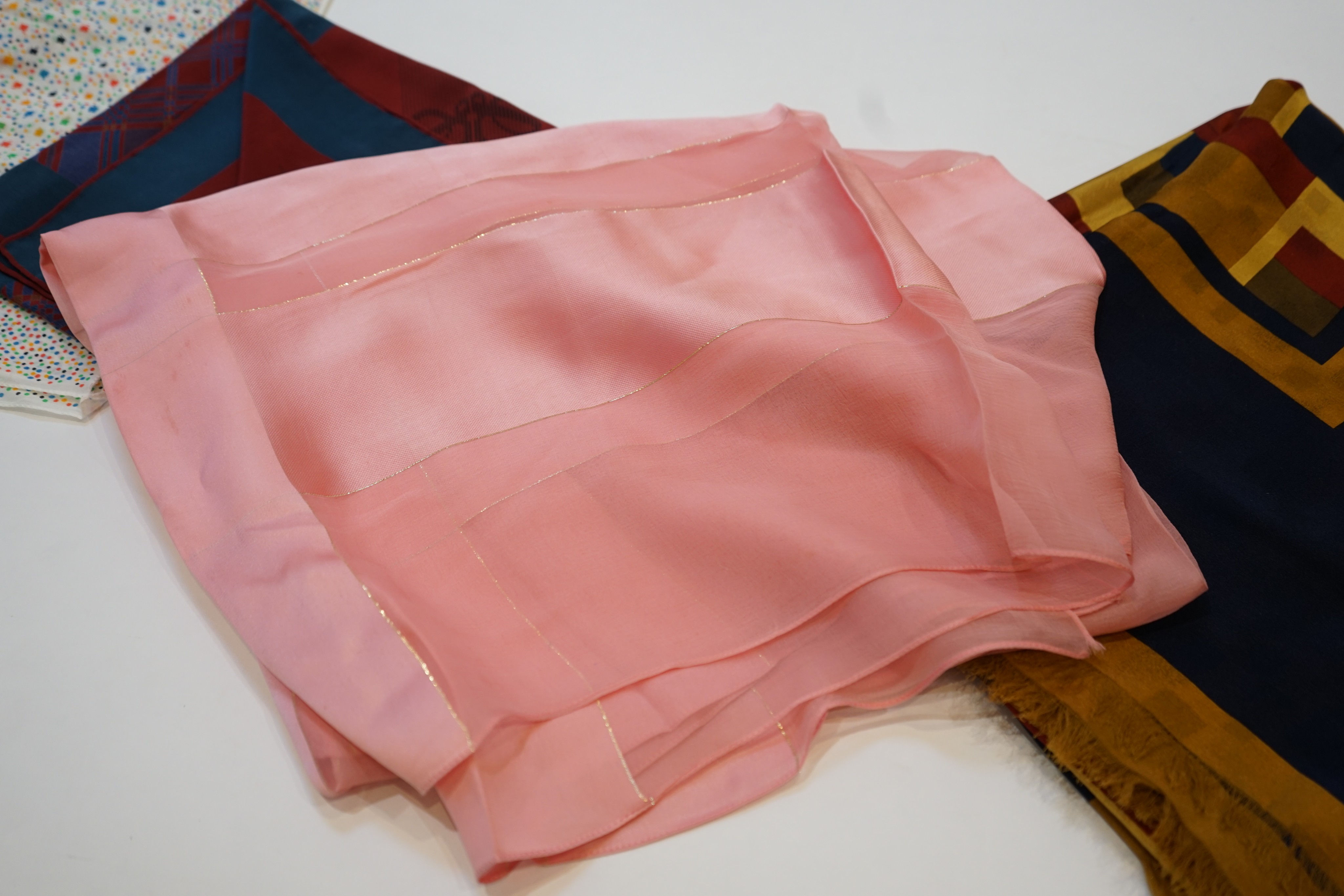 Four assorted scarves; Givenchy cotton, YSL peach chiffon, Christian Dior geometric and Loewe silk